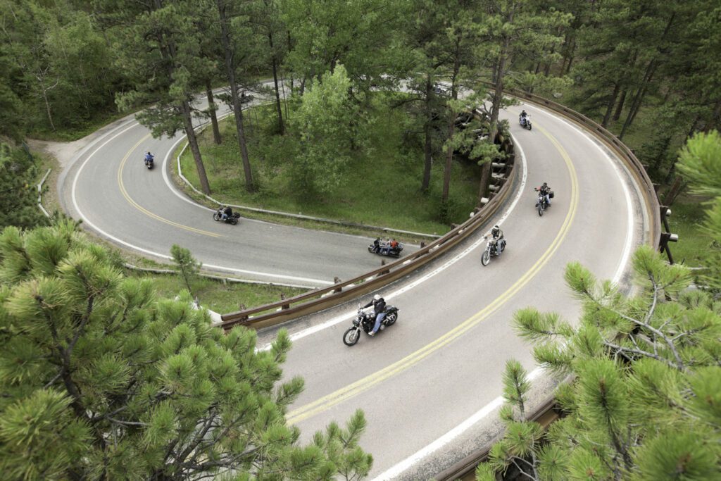 Black Hills,South Dakota, USA - August 7, 2013: 2013 Sturgis Motorcycle Rally Week,a group of motorcyclists out on their Harley Davidson motorcycles riding the country corkscrew roads.